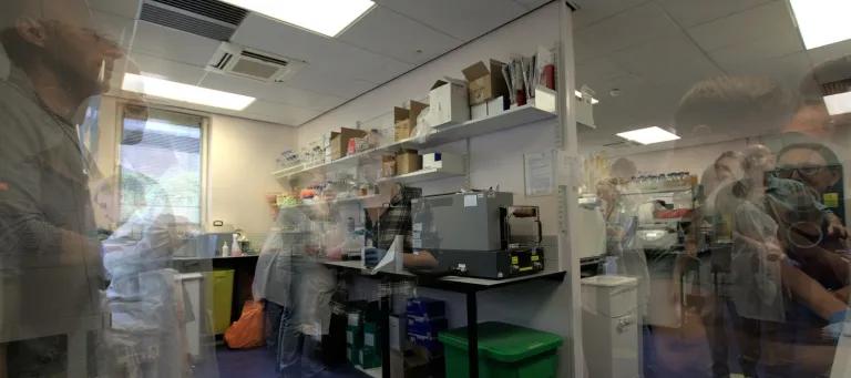 Layered image of technicians working in a research facility