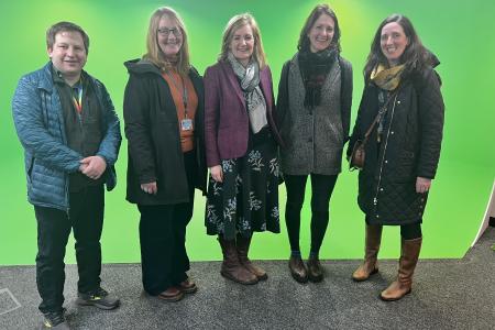 members of the Technician Steering Committee in front of a green screen at UCreate